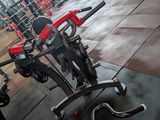 a gym area with a row of exercise equipment
