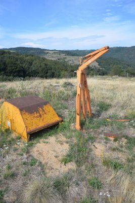 a large piece of wood sitting in the middle of a field
