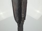 a sculpture of a black object on a clear base