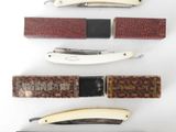 several different types of knives are lined up on a white surface