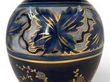 a blue and gold vase with a dragon on it