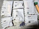 a lot of mail bags and a hammer on a table