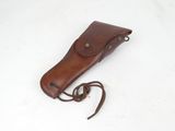 brown leather sheath for a knife on a white surface