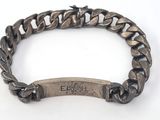 a close up of a bracelet with an engraved bar on it
