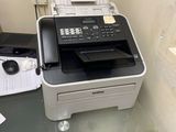 a printer sitting on top of a desk next to a computer