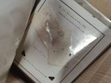 a box with a piece of paper in it and a pair of scissors in it