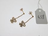 two pairs of earrings and a tag with a price tag
