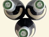 three bottles of wine sitting on top of each other