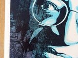 a poster of a woman with glasses on a table