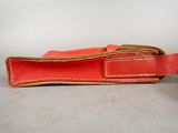an orange belt with a brown buckle on a white background