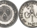 an image of a silver coin with the letter a on it