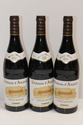 three bottles of wine are lined up on a table