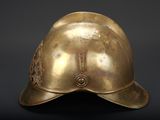 an old brass helmet with a metal emblem on it