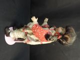 a doll that is laying down on a black surface