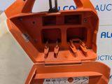 an orange piece of equipment that is sitting on top of a table