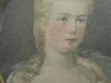 portrait of a woman with a flower in her hair in a gold frame