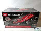 an image of a red lawn mower sitting on top of a box