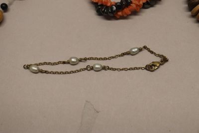 a necklace and bracelet that are on a table