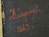 an old book with writing on it sitting on a table