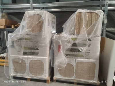 two stacks of boxes are wrapped in plastic and stacked on top of each other