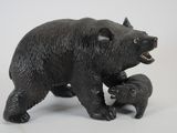 statue of a black bear and her cubs on a white background