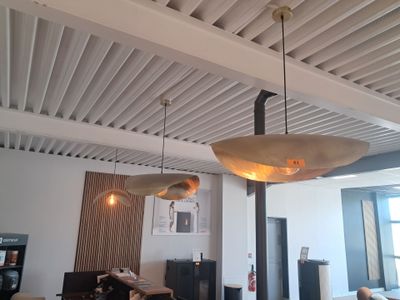 two lamps hanging from the ceiling above a dining room table