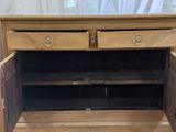 a wooden cabinet with two drawers on top of it