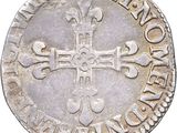 a close up of a coin with a cross on it