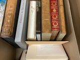 a box full of books on a tiled floor