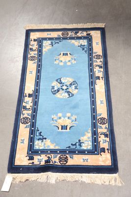 blue and beige oriental rug with oriental design on it