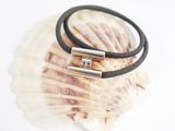 leather bracelet with silver plated clasp on a seashell