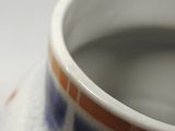 a close up view of a vase with a blue and white design