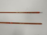 two wooden chopsticks sitting next to each other on a white surface