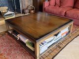 a coffee table in the middle of a living room with pink couches