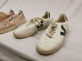 three pairs of new balance tennis shoes on a white sheet
