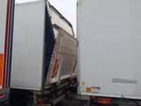 two trucks that are parked next to each other