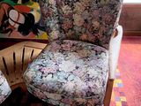 two chairs in a room with a painting on the wall behind them