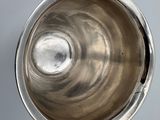a silver bowl with a silver lid on a table