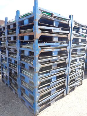 pallets stacked on top of each other in a parking lot