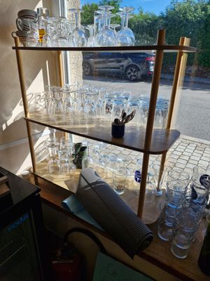 many glasses on the shelves in the room