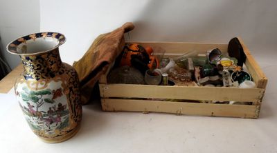 a wooden crate with a vase and other items in it