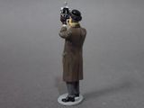 a figurine of a man holding a gun