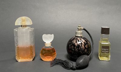 three bottles of perfume sitting next to each other on a table