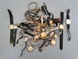 a lot of watches that are laying on the table