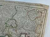an old map of europe on a table with a pen and paper