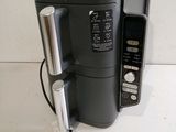 a black and silver coffee maker sitting on a counter