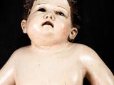 a small child that is sitting on a black surface