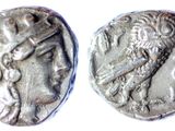 a close up of a coin with a roman head on it