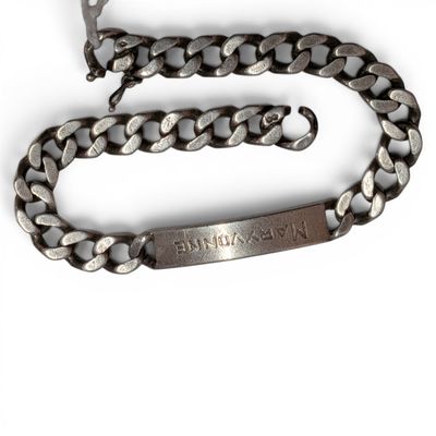 an image of a silver chain bracelet with a name engraved on it