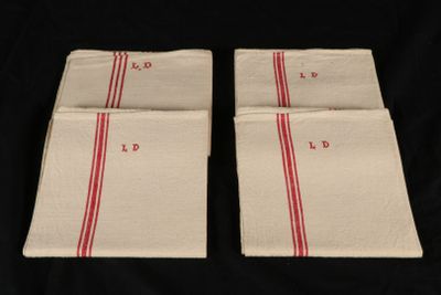 two red and white napkins on a black background